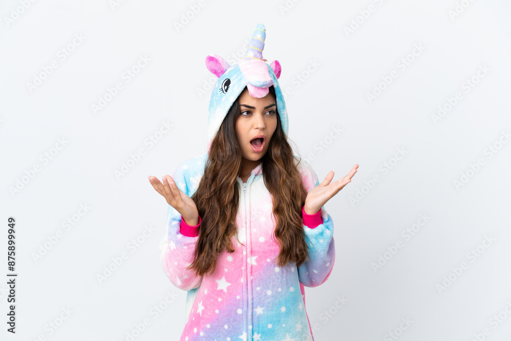 Young caucasian woman wearing a unicorn pajama isolated on white background with surprise facial expression Young caucasian woman wearing a unicorn pajama isolated on white background with surprise facial expression