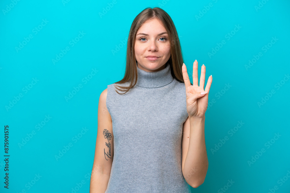 Young Lithuanian woman isolated on blue background happy and counting four with fingers Young Lithuanian woman isolated on blue background happy and counting four with fingers