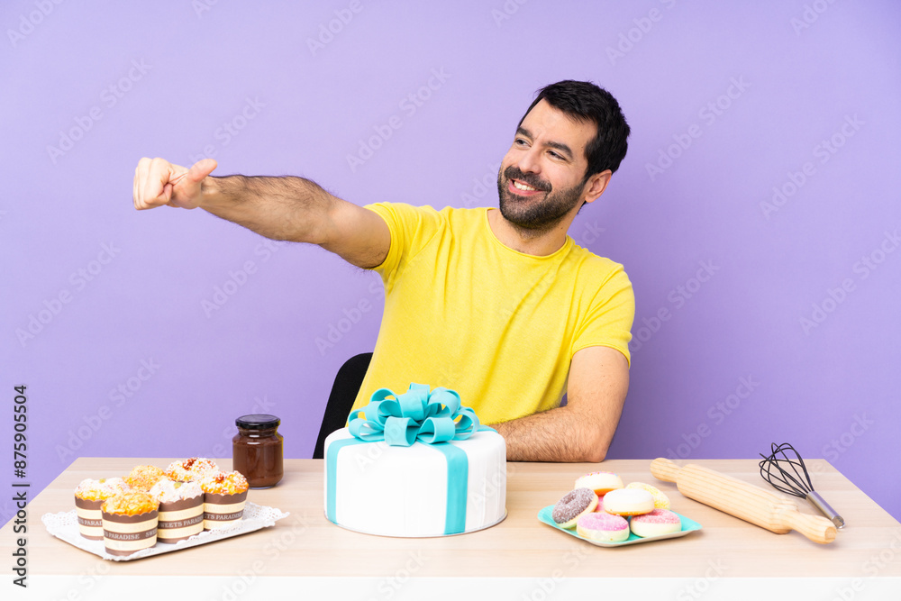 Man in a table with a big cake giving a thumbs up gesture Man in a table with a big cake giving a thumbs up gesture