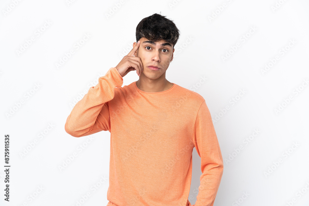 Young man over isolated white background thinking an idea Young man over isolated white background thinking an idea