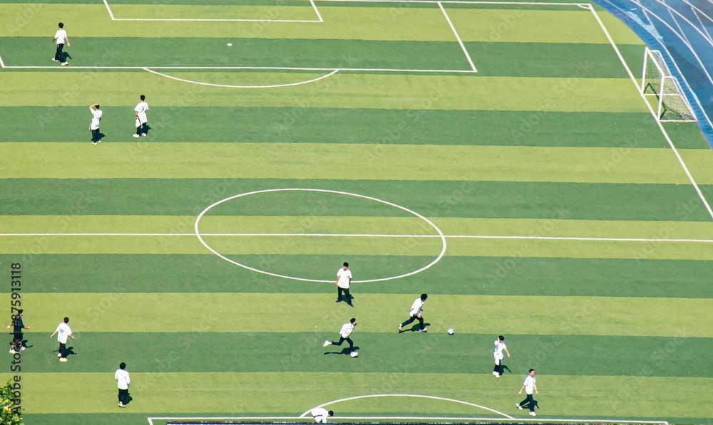 Aerial view over a soccer field with players practicing on a summer day