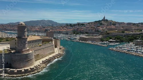 video from a drone flying over ships and ships in the marina in the center of Marseille, France on a sunny summer day