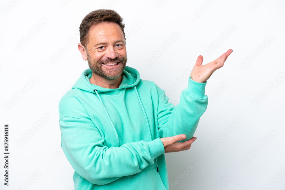 Middle age caucasian man isolated on white background extending hands to the side for inviting to come Middle age caucasian man isolated on white background extending hands to the side for inviting to come