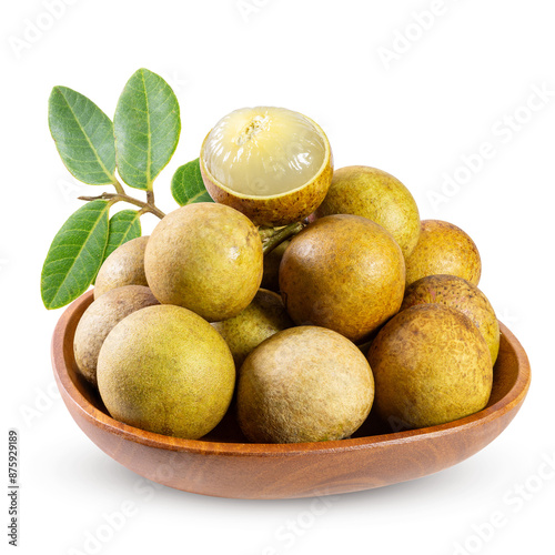 Longan fruits with leaves in a wooden bowl isolated on white background