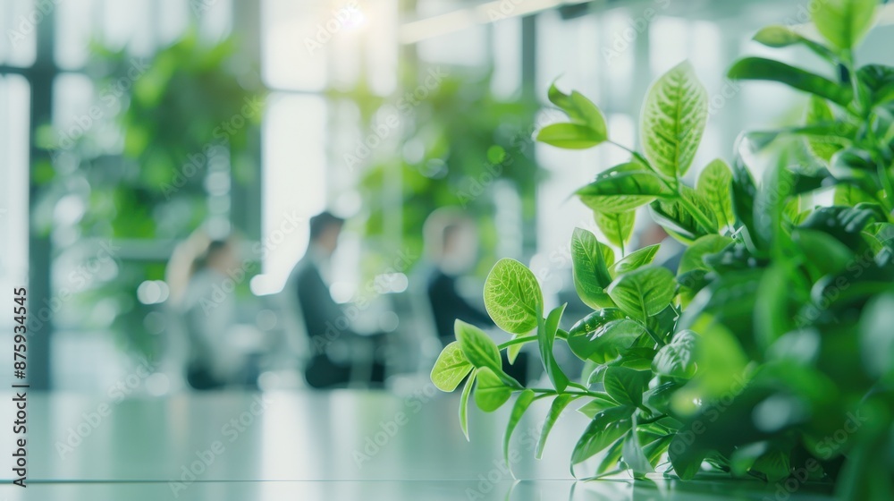 Modern office environment with green plants and out-of-focus people, creating an eco-friendly and productive workspace. Modern office environment with green plants and out-of-focus people, creating an eco-friendly and productive workspace.