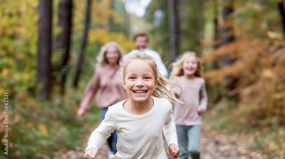 A family is running through a forest, with a young girl in the middle A family is running through a forest, with a young girl in the middle