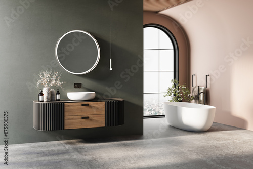 Modern bathroom interior with brown parquet floor, green and orange walls, vanity white sink, oval mirror, bathtub, interior plants, front view.Minimalist bathroom with modern furniture