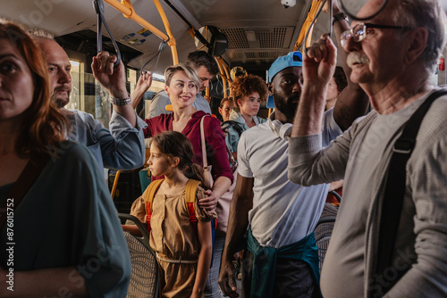 Quadro em tela Multigenerational group of travelers on a busy electric eco-bus