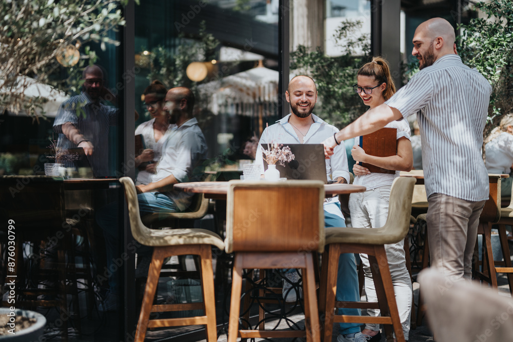 A group of business workers collaborating in a coffee bar, brainstorming ideas and sharing knowledge while working remotely. A group of business workers collaborating in a coffee bar, brainstorming ideas and sharing knowledge while working remotely.