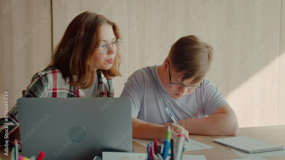 Person with disability copying information from pc to papers Person with disability copying information from pc to papers