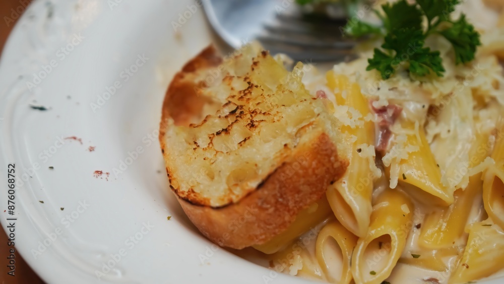 Creamy pasta with mushrooms, bacon, and a side of garlic bread. Creamy pasta with mushrooms, bacon, and a side of garlic bread.