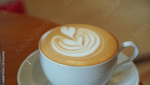 A white cup of coffee with latte art.