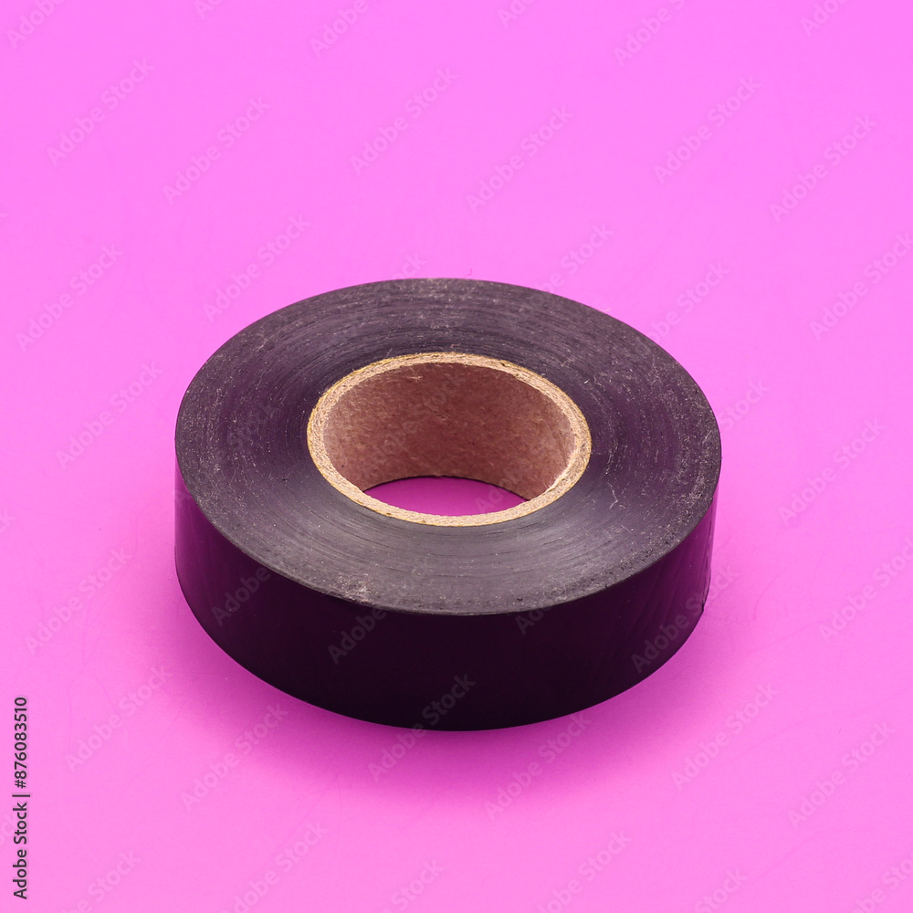 Black Electrical Tape isolated on purple background Black Electrical Tape isolated on purple background