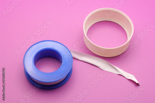 Thread seal tape (plumber's tape) isolated on purple background photo