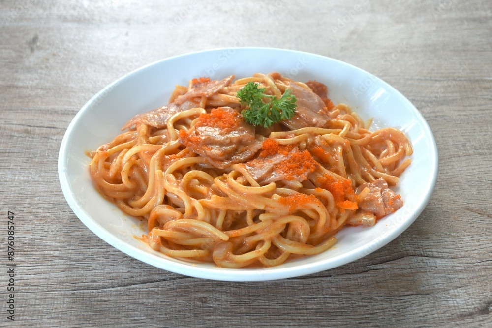 spicy stir fried spaghetti with slice ham pork dressing Rose Korean sauce topping shrimp egg on plate spicy stir fried spaghetti with slice ham pork dressing Rose Korean sauce topping shrimp egg on plate