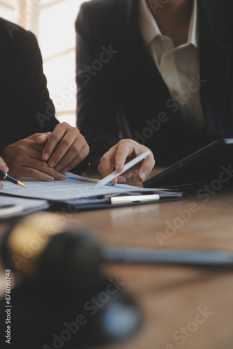 Lawyer, legal advisor, businessman brainstorming information on agreement details Business contracts in legal processing books for accuracy in contract documents. joint financial investment.