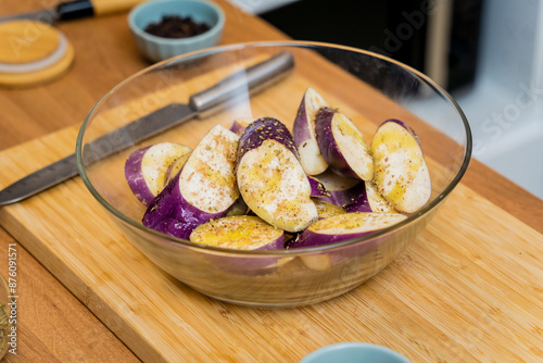 Delicious raw eggplants with garlic in the glass bowl