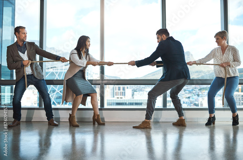 Business people, rope and pulling in office for challenge with tug of war, rival company and strong teamwork. Staff, collaboration and help with opposition, partnership and work competition or battle photo