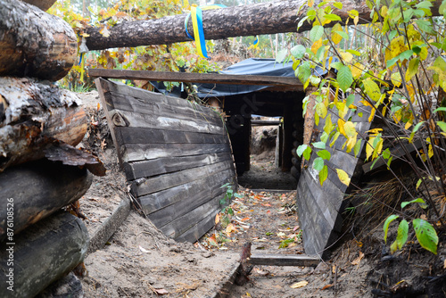 Fortified earthen structure built by Ukrainian soldiers in the forest for war battles. War in Ukraine.