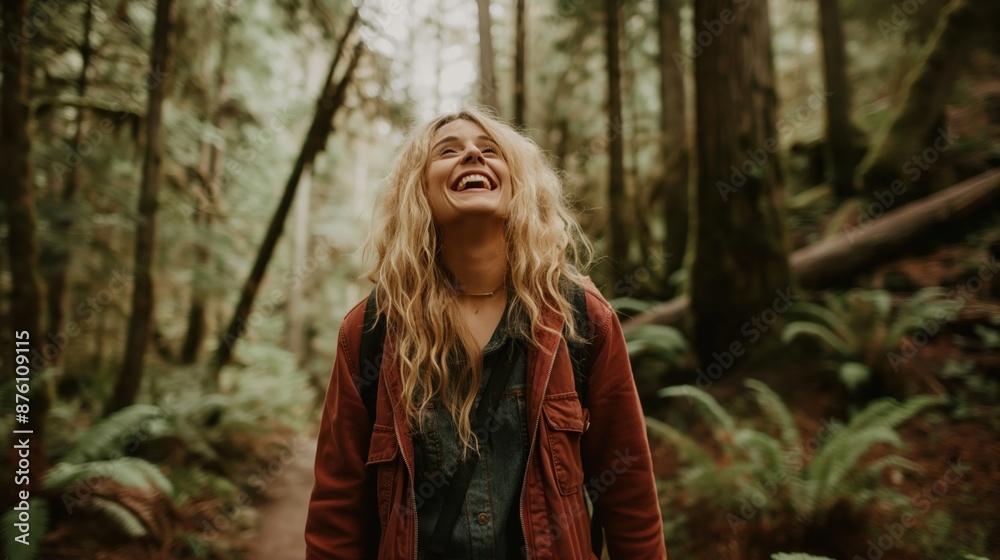 Woman laughing and walking through a forest. Natural joy and engagement with nature are the focal points of this scene Woman laughing and walking through a forest. Natural joy and engagement with nature are the focal points of this scene