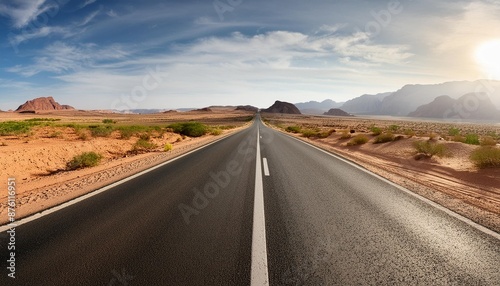 panoramic image of a lonely seemingly endless road in the desert