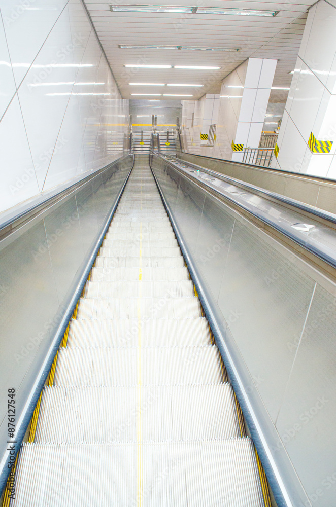 An escalator is going up in a subway station.Mechanical escalator in the international airport or modern subway train station An escalator is going up in a subway station.Mechanical escalator in the international airport or modern subway train station