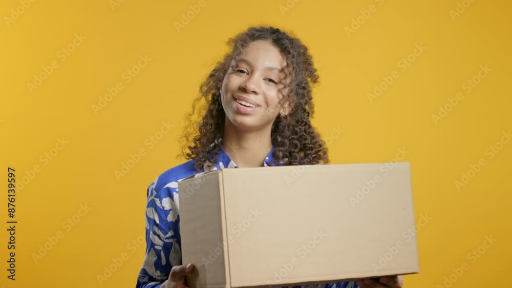 Excited smiling african american teenager girl, online shopping consumer received cardboard order parcel box, desired purchase. Home courier delivery service. Sale, discounts Excited smiling african american teenager girl, online shopping consumer received cardboard order parcel box, desired purchase. Home courier delivery service. Sale, discounts