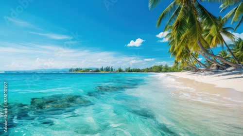 Scenic tropical beach with turquoise water, palm trees swaying under a bright blue sky