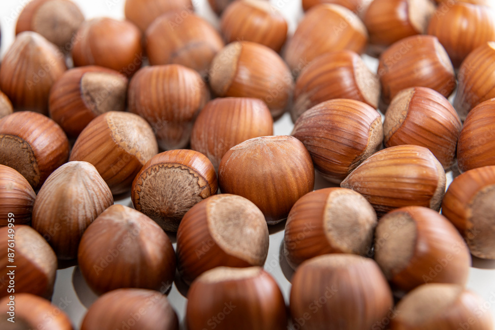 natural hazelnuts on white surface - close macro photo natural hazelnuts on white surface - close macro photo