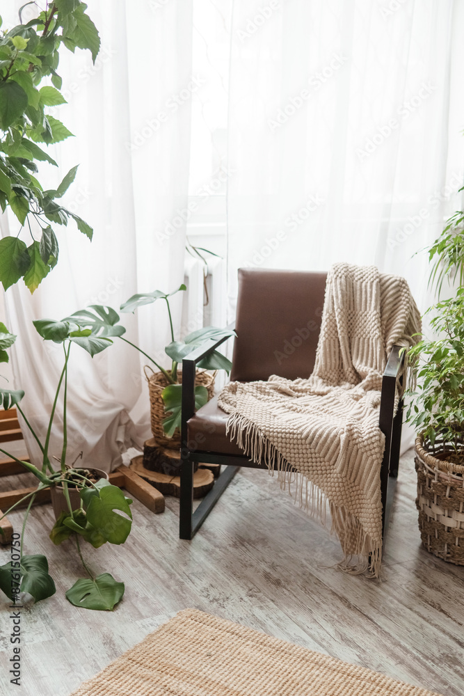 A fragment of the interior with a variety of indoor plants and plaster sculptures. Urban jungle concept. Biophilia design.