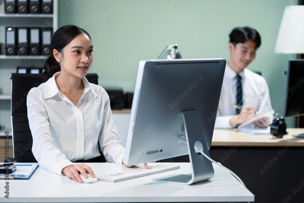 Business man and business woman sitting on desk using Tablet and laptop, working environment. Happy businessteam in casual working on computer in office. Business man and business woman sitting on desk using Tablet and laptop, working environment. Happy businessteam in casual working on computer in office.