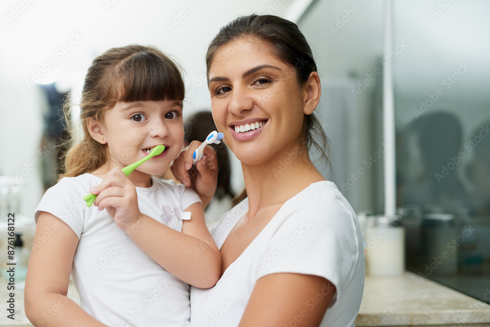 Mother, child and brushing teeth portrait for family dental hygiene, health and wellness learning with smile. Home, bathroom and young girl with toothbrush, teeth and cleaning at morning with care Mother, child and brushing teeth portrait for family dental hygiene, health and wellness learning with smile. Home, bathroom and young girl with toothbrush, teeth and cleaning at morning with care
