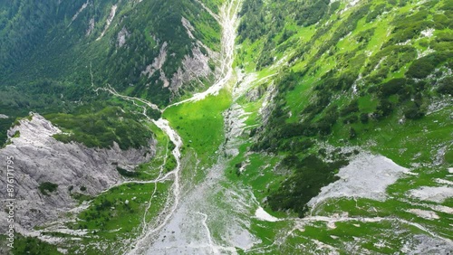 An awe-inspiring aerial view of the Slovenian Alps, featuring the majestic peaks of Viševnik, Jezerca, and Veliki Draški vrh. These stunning mountains offer breathtaking hiking trails photo