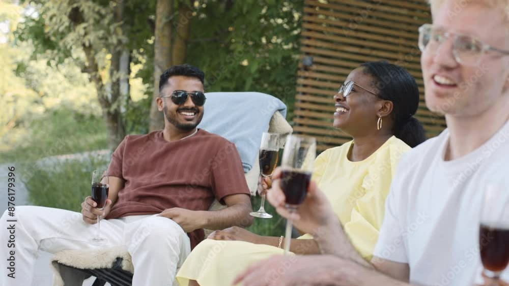 A group of diverse friends enjoy a summer picnic together A group of diverse friends enjoy a summer picnic together