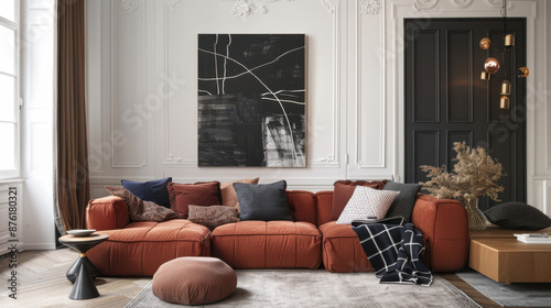A contemporary cozy living space, rust-colored sectional sofa, navy and blush pink round cushions © otter2