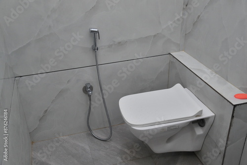 Toilet in the room with hand wash and toilet seat