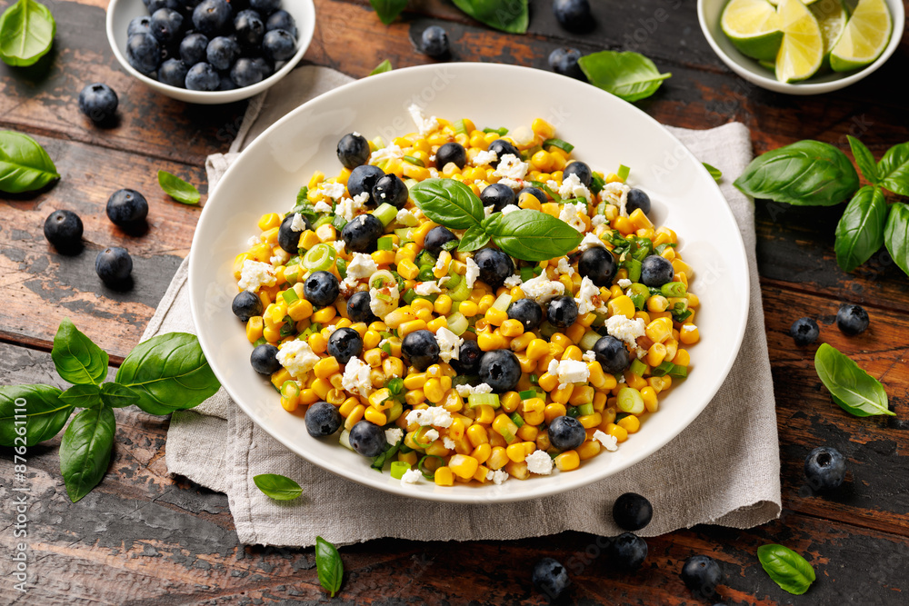 Blueberry Corn Feta Salad in white plate on wooden table. Healthy food Blueberry Corn Feta Salad in white plate on wooden table. Healthy food