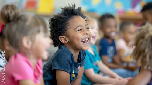 A group of children are sitting in a classroom and one of them is smiling. Scene is happy and cheerful