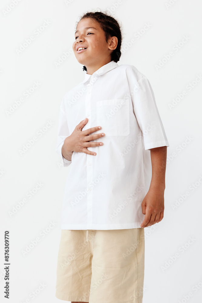 Confident young boy in stylish outfit stands with hands on hips in trendy pose Confident young boy in stylish outfit stands with hands on hips in trendy pose