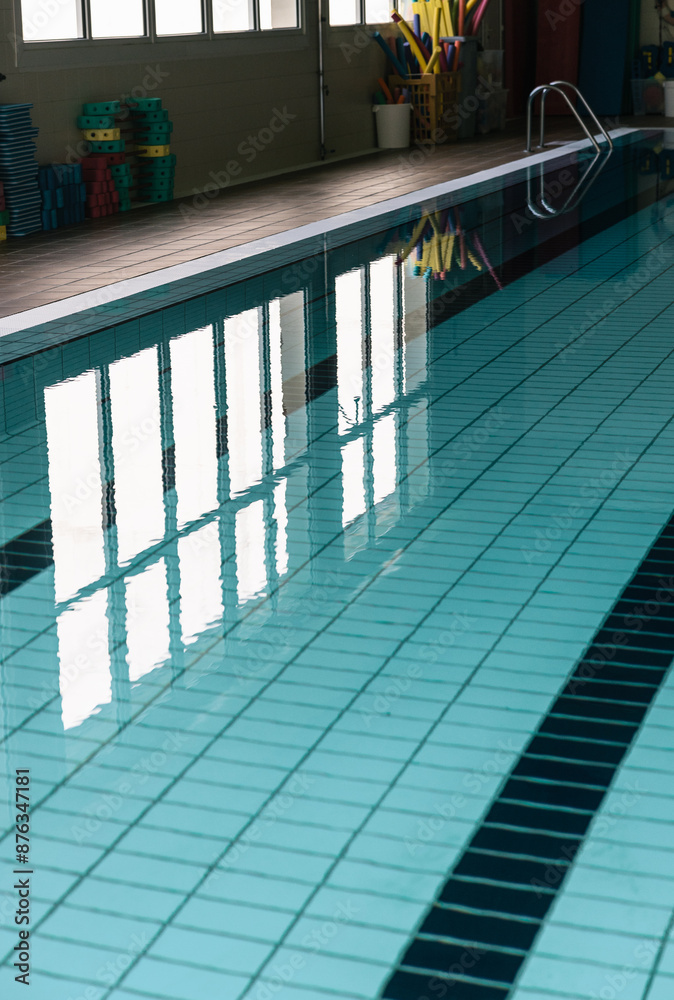Fototapeta premium Clear water reflections in an indoor swimming pool lane