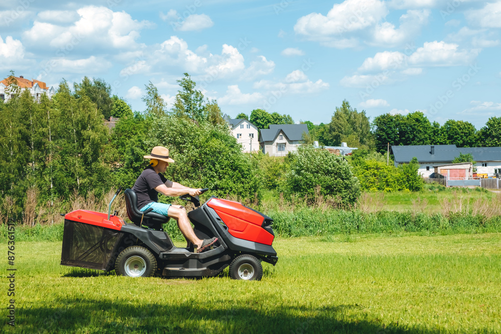 Man on lawn tractor mowing lawn on backyard. The red rider. The lawnmower tractor. High quality 4k footage Man on lawn tractor mowing lawn on backyard. The red rider. The lawnmower tractor. High quality 4k footage