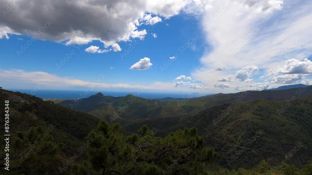 Clouds on blue sky over mountains and sea in Sierra de las Nieves National Park, Andalusia, southern Spain Clouds on blue sky over mountains and sea in Sierra de las Nieves National Park, Andalusia, southern Spain