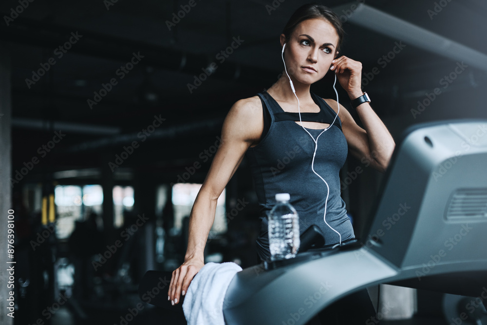 Running, music and woman on treadmill in gym listening to podcast, audio and radio for cardio workout. Sports, wellness and person with earphones for exercise, marathon training and fitness for race Running, music and woman on treadmill in gym listening to podcast, audio and radio for cardio workout. Sports, wellness and person with earphones for exercise, marathon training and fitness for race
