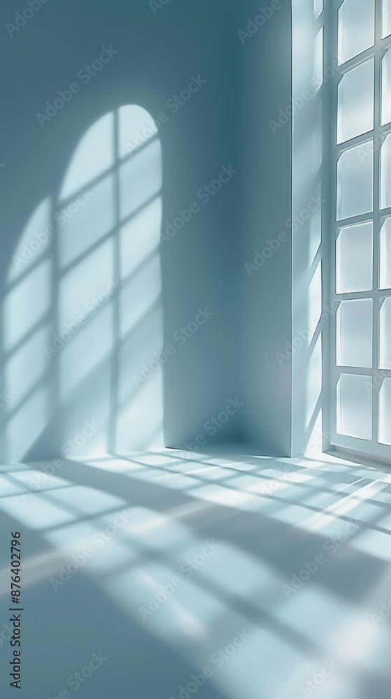 Obraz premium Sunlight Streaming Through Window Casting Geometric Shadows in Minimalist Blue Room – Tranquil, Bright, and Serene Interior Scene
