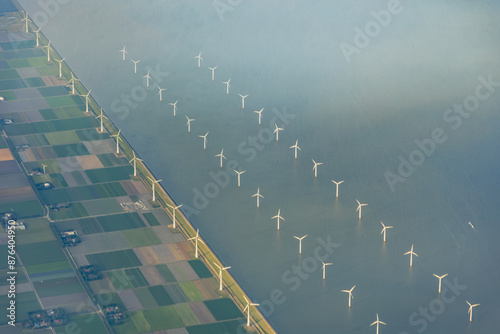 Aerial view of offshore wind farm with wind turbine and windmills double row in the IJsselmeer lake near former island of Urk