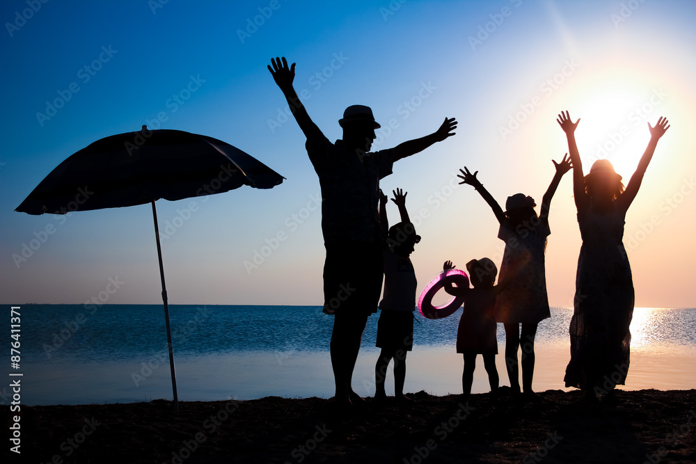 A Happy family by the sea at sunset in travel silhouette in nature