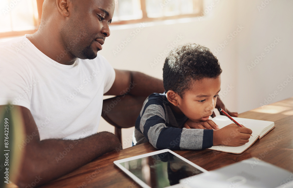 Homework, help and dad with child and writing youth in family home with notebook and parent support. Learning, development and young student with education and school study for reading at table Homework, help and dad with child and writing youth in family home with notebook and parent support. Learning, development and young student with education and school study for reading at table