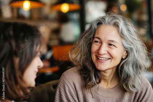 Wallpaper Mural Portrait of two cute smiling women in cafe. One is older with gray hair, the other with dark curly hair. Self-acceptance. Body positive. Torontodigital.ca