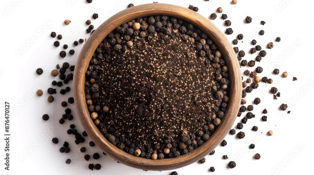 A wooden bowl filled with black pepper seeds for culinary or decorative use A wooden bowl filled with black pepper seeds for culinary or decorative use