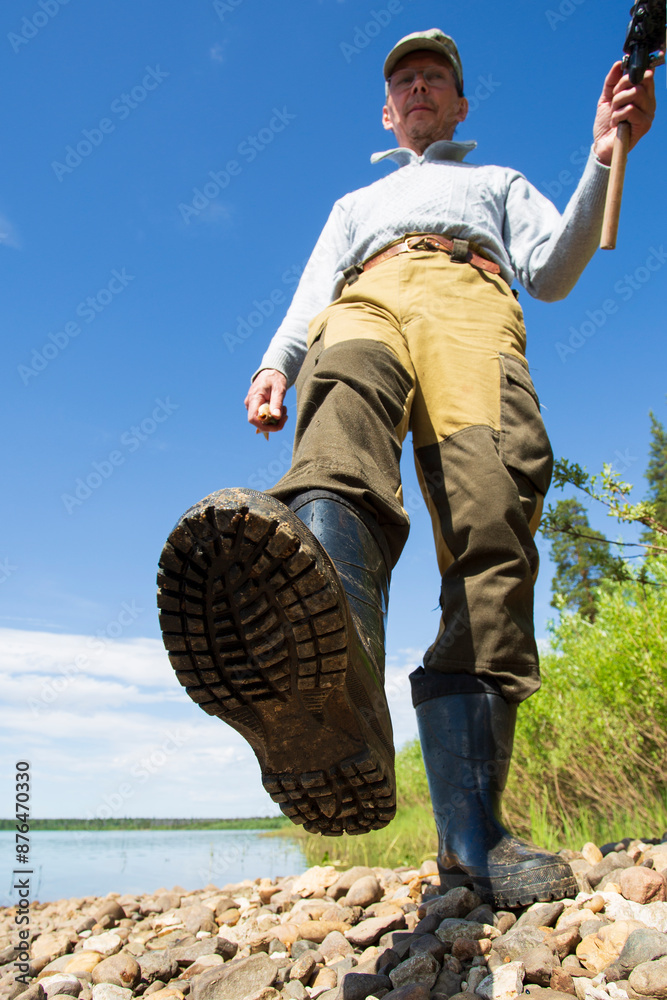 A man with a spinning is fishing on the river. A man with a spinning is fishing on the river.